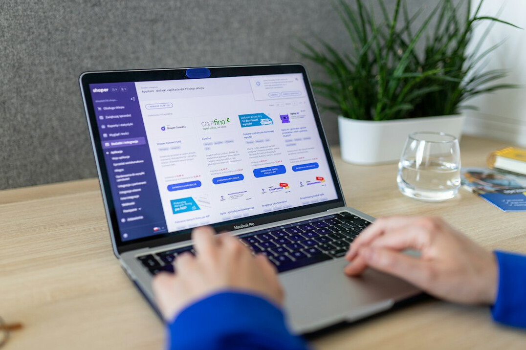 person tracking stocks on laptop